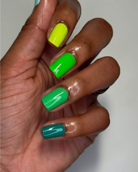 Multishade green nails with the lightest green  on the top section and the darkest  on the bottom of the nail stack.